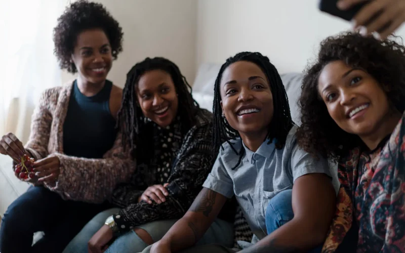 Female friends relaxing at home taking self portrait photo